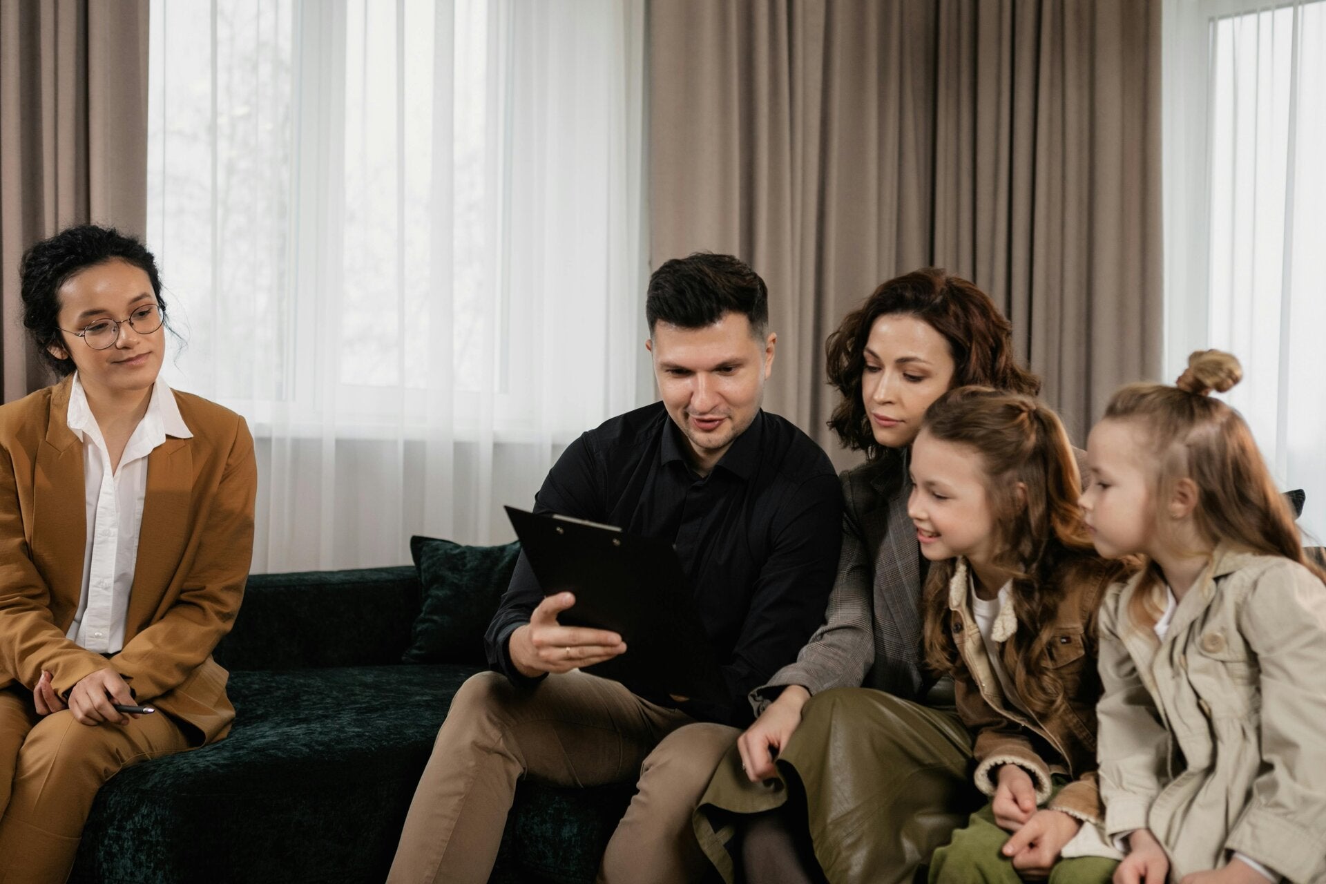 A family and support professional reviewing information together.