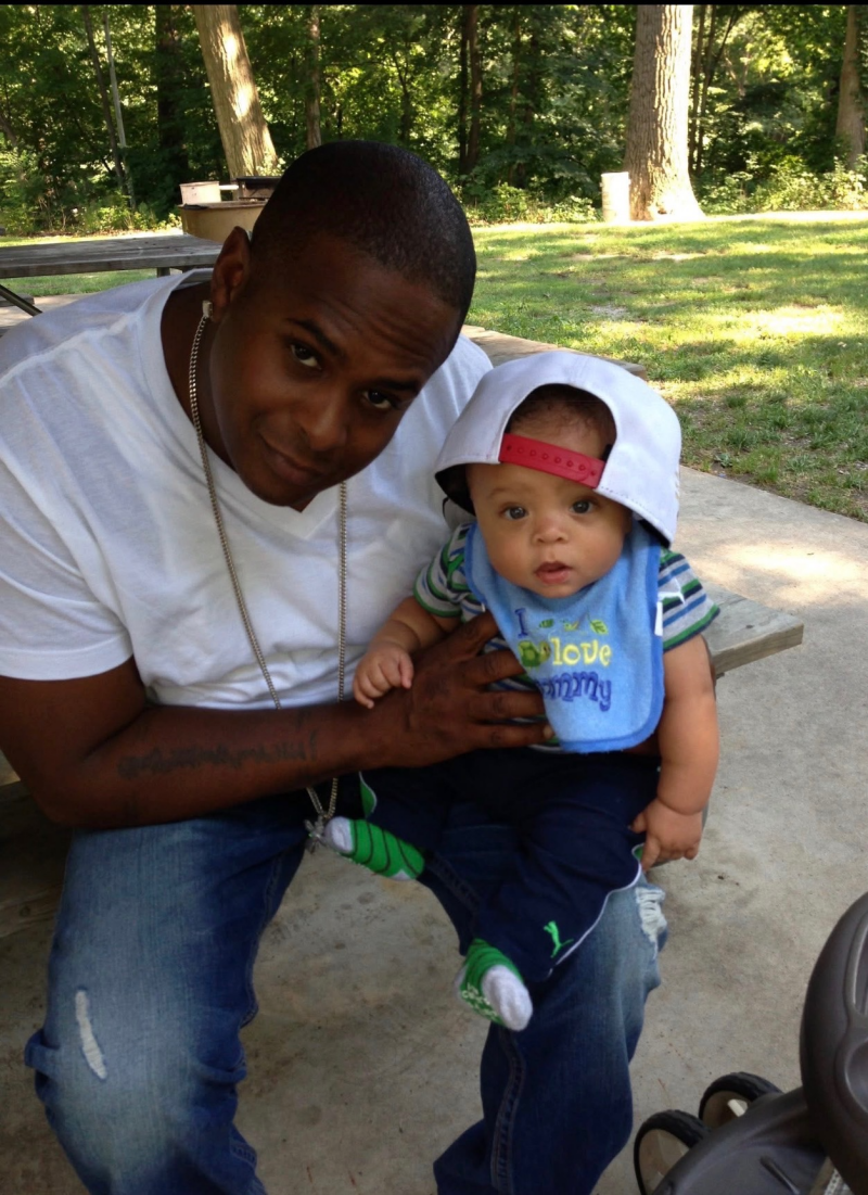 Founder with DJ as a toddler, outdoors.